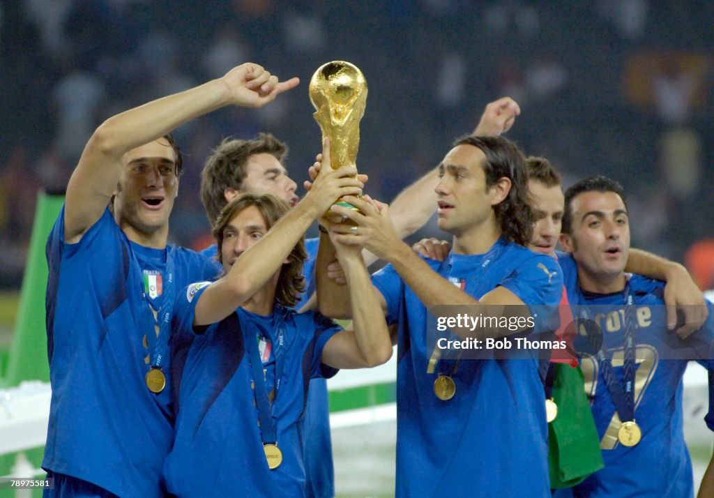 BT Sport. Football. FIFA World Cup Final. Berlin. 9th July 2006. Italy 1 v France 1. (after extra time). Italy won 5-3 on Penalties. Italy's Andrea Pirlo and Alessandro Nesta lift the trophy together with the celebrating players.