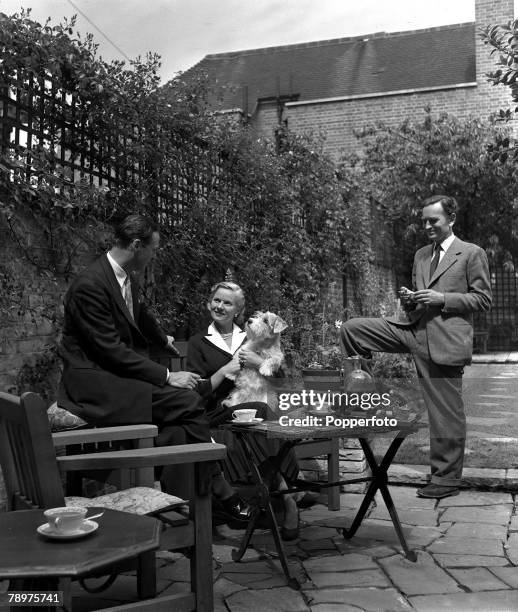 British film actress Ann Todd and her husband producer and director David Lean pictured at their Kensington home, with British playwright Terrence...