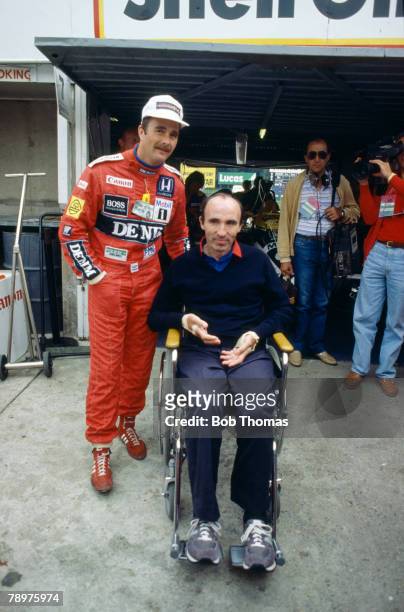 British racing driver Nigel Mansell, driver of the Canon Williams Honda Williams FW11 Honda RA166E 1.5 V6 t, pictured with Williams Honda team "boss"...