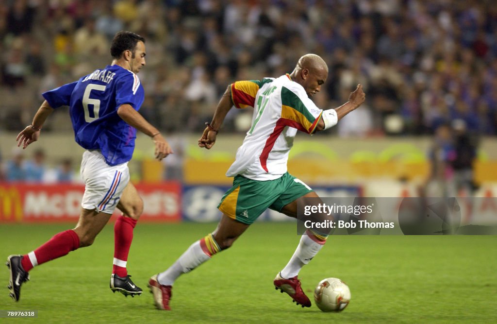 BT Football. FIFA World Cup Finals. Korea. Seoul. 31st May 2002. France 0 v Senegal 1. Senegal's Hadji El Diouf chased by France's Youri Djorkaeff.