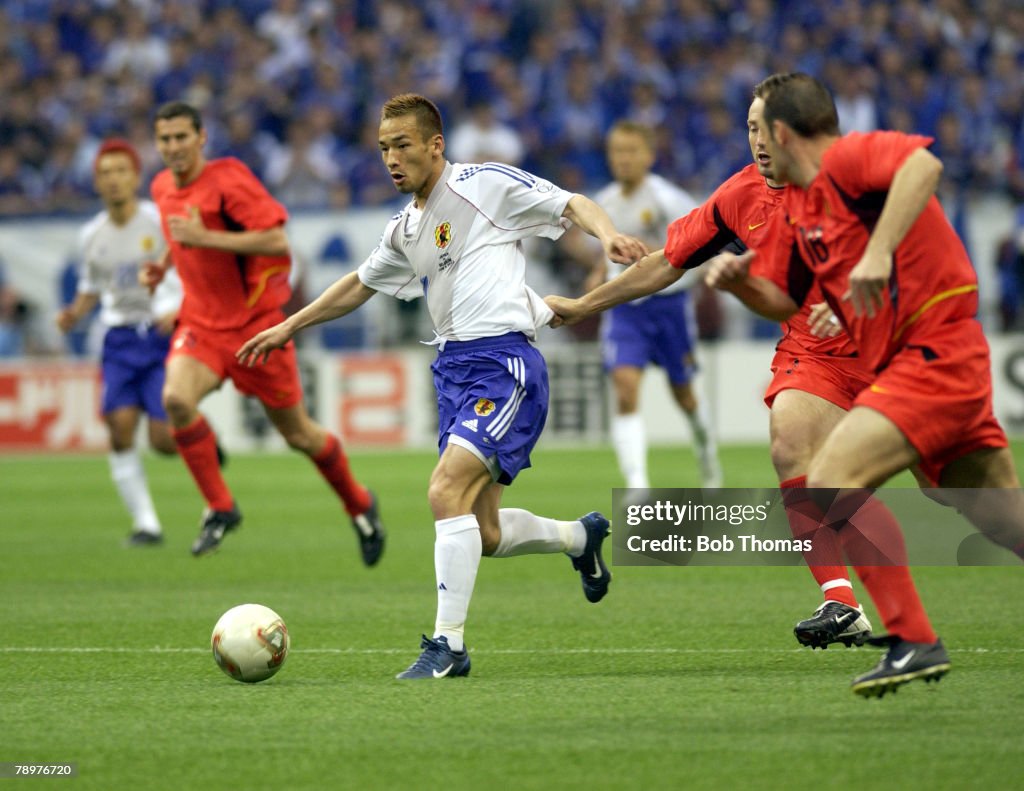 BT Football. 2002 FIFA World Cup Finals. Saitama, Japan. 4th June 2002. Japan 2 v Belgium 2. Japan's Hidetoshi Nakata passes the challenge of Belgium's Marc Wilmots.