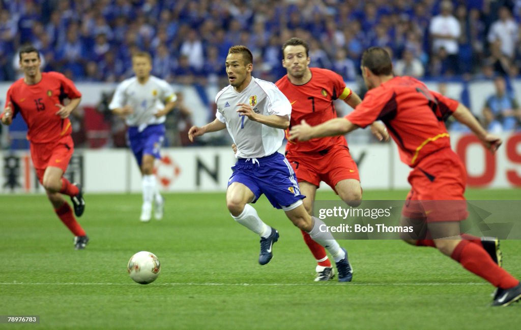 BT Football. 2002 FIFA World Cup Finals. Saitama, Japan. 4th June 2002. Japan 2 v Belgium 2. Japan's Hidetoshi Nakata passes the challenge of Belgium's Marc Wilmots.
