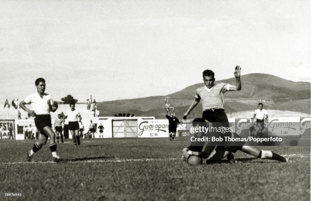 Sport. Football. World Cup Finals. 2nd July 1950. Bela Horizonte, Brazil. Uruguay 8. v Bolivia 0. Uruguay forward Julio Perez is thwarted by Bolivian goalkeeper Guttierrez who dives bravely at his feet to save. Uruguay's goals were scored by Schiaffino (4