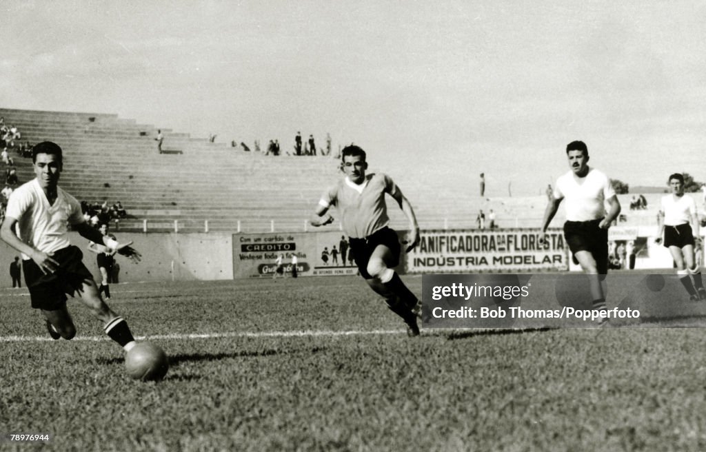 Sport. Football. World Cup Finals. 2nd July 1950. Bela Horizonte, Brazil. Uruguay 8. v Bolivia 0. Uruguay forward Julio Perez, (centre) races through the Bolivian defence in the match which attracted a modest crowd of just 10,000 people. Uruguay's goals w