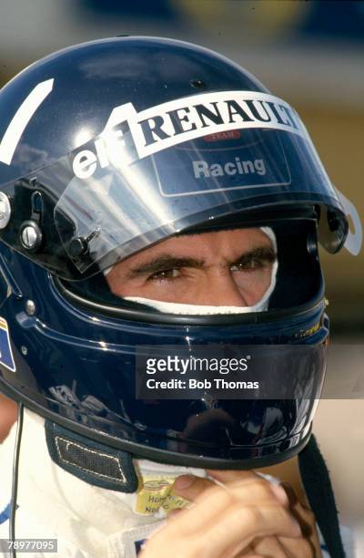 British Formula One racing driver Damon Hill pictured wearing his racing helmet during competition to drive the Rothmans Williams Renault Williams...