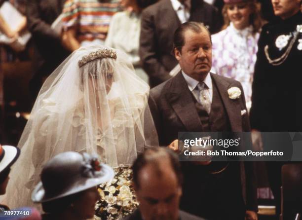 Lady Diana Spencer walks down the aisle with her father, the Earl Spencer, at her wedding to Prince Charles at St Pauls Cathedral, London, 29th July...