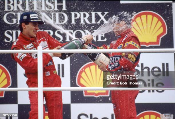 Ayrton Senna of Brazil, driver of the Honda Marlboro McLaren McLaren MP4/4 Honda RA168E 1.5 V6 turbo pictured on left celebrating by spraying a large...