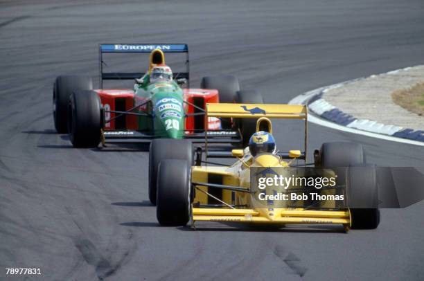 British racing driver Derek Warwick drives the Camel Team Lotus Lotus 102 Lamborghini 3512 3.5 v12 ahead of Brazilian racing driver Nelson Piquet in...