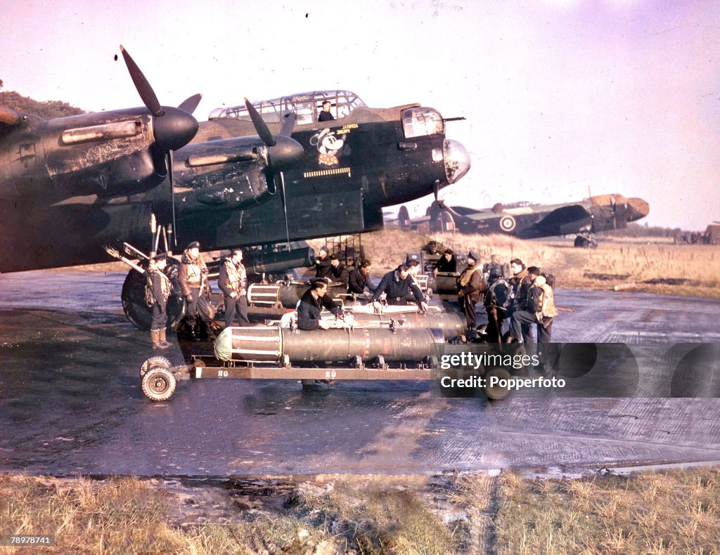 World War II. 1942. The crew of Lancaster bomber +Admiral Prune+ stands by as their plane is prepared for a mine-laying operation.