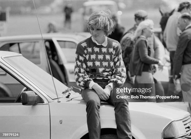 British Royalty, Smith's Lawn, Windsor, England, June 1981, Lady Diana Spencer sits on the bonnet of a car as she watches Prince Charles play polo