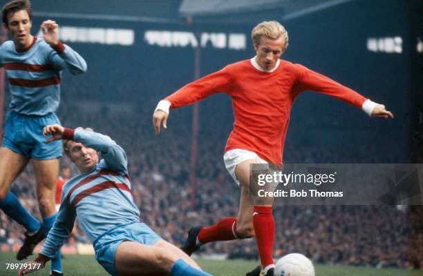 S, Division 1, Manchester United's Denis Law beats a challenge from West Ham United's Bobby Moore