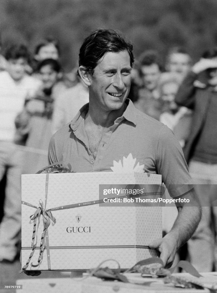 British Royalty. Smith's Lawn, Windsor, England. 1983. Prince Charles holding his polo prize by Gucci.