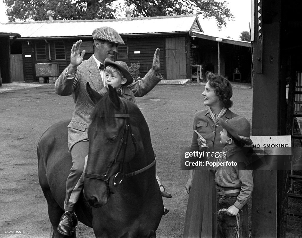 1953. Lt Colonel Harry Llewellyn pictured on his horse with his wife and their sons David and Roddy, at their stables Gobin Manor, Abergavenny, Wales.