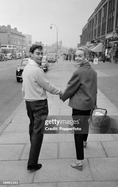 London, England, British film and movie actress Shirley Eaton walks hand in hand with her fiancee Colin Lenton-Rowe down a street