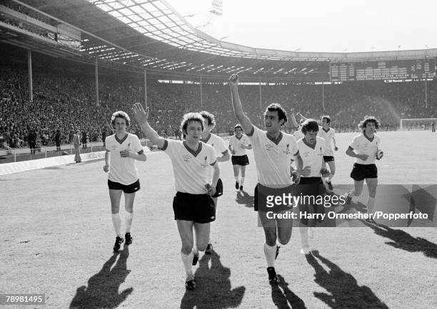 Liverpool players acknowledge their fans after the FA Cup Final between Liverpool and Manchester United at Wembley Stadium on May 21, 1977 in London,...