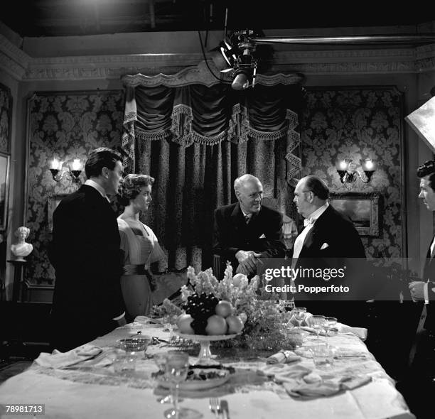 Brian Worth, Eileen Moore, Alistair Sim and Julian Mitchell in a scene from the film "An Inspector calls"