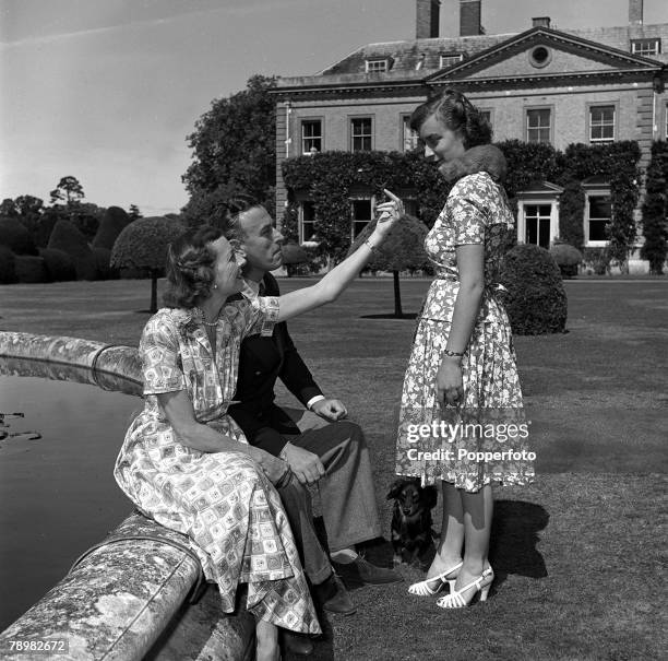 Lady Mountbatten and Lord Mountbatten with their daughter, Pamela in the grounds of their "Broadlands" home, on Pamela's shoulder is Rikki the...