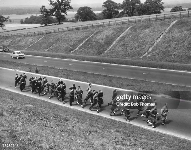 16th July 1962, near London Colney, Hertfordshire, The Arsenal players jog along the A6 road, their first spell of roadwork in the preparation for...