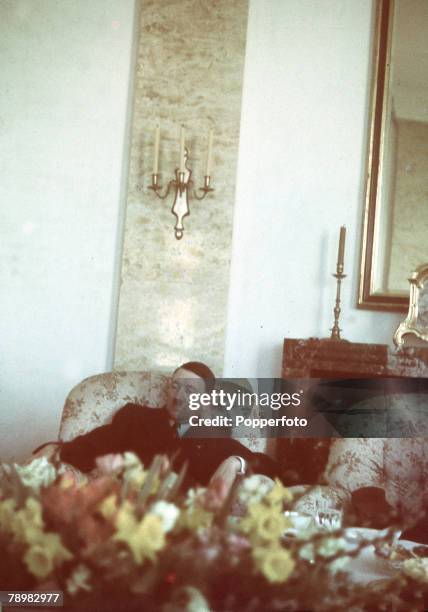 Circa 1930's, German leader Adolf Hitler reclining in an armchair at the Teehaus, a small pavilion near the Berghof