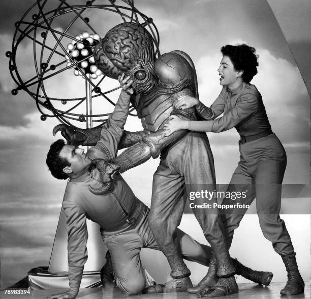 Rex Reason and Faith Domergue battle with a mutant alien in the film +This Island Earth+