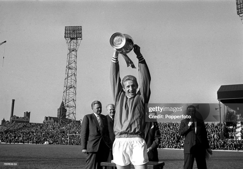 Sport. Football. pic: 19th May 1965. Inter-Cities Fairs Cup. Quarter Final. Manchester United.0. v Racing Strasbourg.0. Manchester United's Denis Law raises the League Championship trophy at Old Trafford after United had won the the Division I title for s