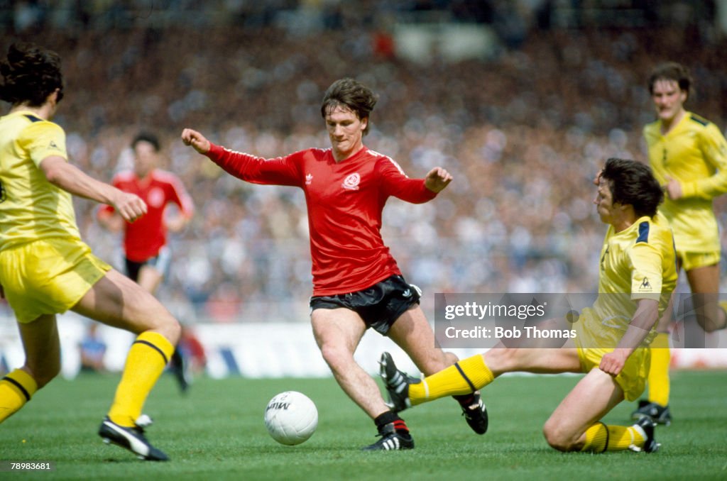 Sport. Football. FA Cup Final at Wembley. pic: 22nd May 1982. Tottenham Hotspur 1 v Queens Park Rangers 1 a.e.t. Queens Park Rangers' striker Simon Stainrod takes on the Tottenham Hotspur defence with Steve Perryman attempting a tackle.