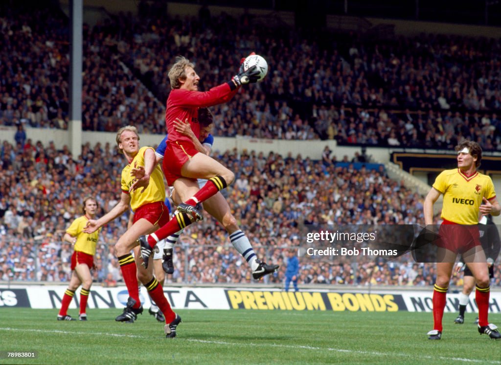 BT Sport. Football. FA Cup Final at Wembley. pic: 19th May 1984. Everton 2 v Watford 0. Watford goalkeeper Steve Sherwood catches the ball as he beats Everton striker Andy Gray. Watford's George Reilly and Steve Terry, right, look on.