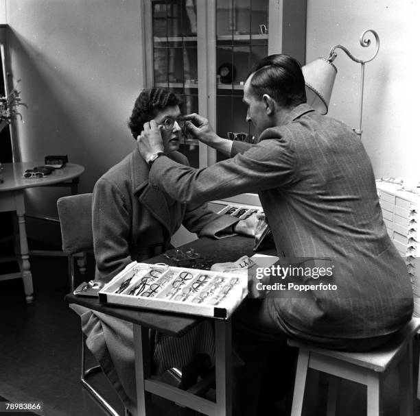 The National Health Service at work in Portsmouth, here a lady tries out her new glasses as eighteen million pairs have been supplied to the Health...