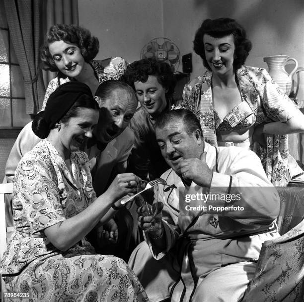 American Film comedians and actors, Lou Costello and Bud Abbott with women writers, Vivien Hill and Joyce Whiting and two Tiller girls playing party...