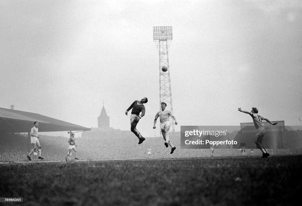 Sport. Football. pic: 31st December 1960. Division 1. Manchester United 5.v Manchester City 1 at Old Trafford. Manchester United's Alex Dawson (centre,dark shirt) stretches for a high ball, as Manchester City's Denis Law (far right) soon to play for Unite