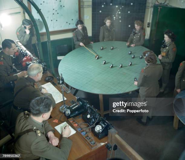 View of Major General E Tremblett of the British Army, with his staff of officers, directing anti-aircraft fire in the London area as they watch the...