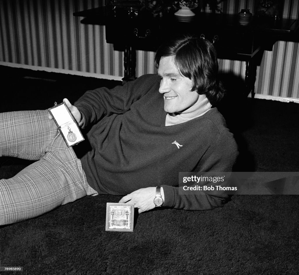 circa 1970's, Arsenal defender Pat Rice at home, with valued medals ...
