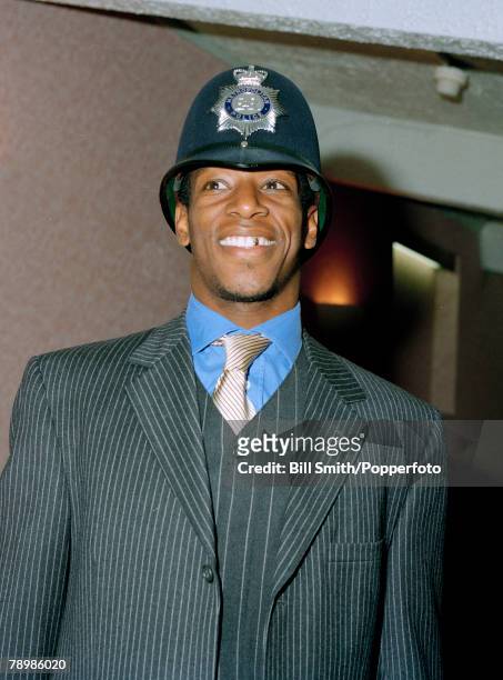 Circa 1990s, Arsenal striker Ian Wright wearing a policeman's helmet