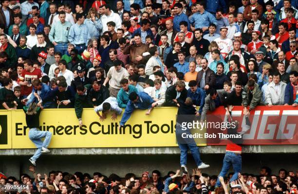 15th April 1989, F.A. Cup Semi-Final at Hillsborough, Liverpool 0,v Nottingham Forest 0, Match Abandoned, Liverpool fans are pulled to safety on to...