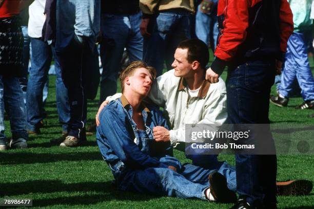 15th April 1989, F.A. Cup Semi-Final at Hillsborough, Liverpool 0,v Nottingham Forest 0, Match Abandoned, An injured fan is comforted by a friend