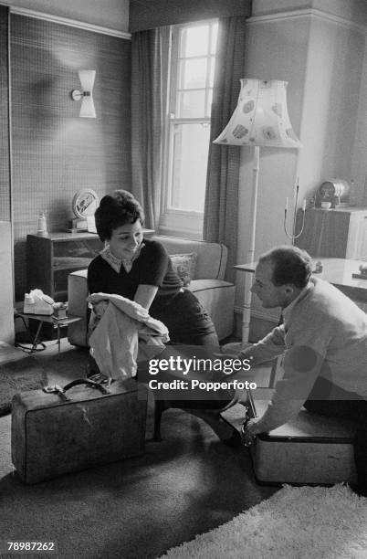 Sport, Motor Racing, England Racing driver Stirling Moss at home with fiance Katie both packing some suitcases with clothes