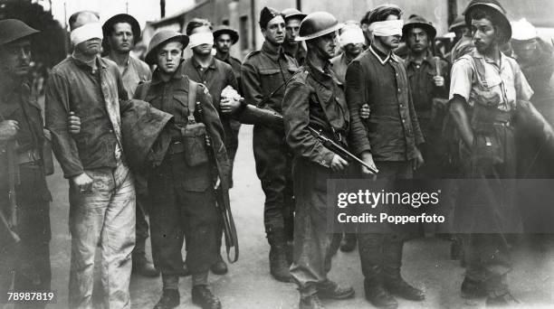 War and Conflict, World War 2, The Dieppe Raid, pic: August 1942, Canadian soldiers stand guard over bindfolded German soldiers captured and taken to...