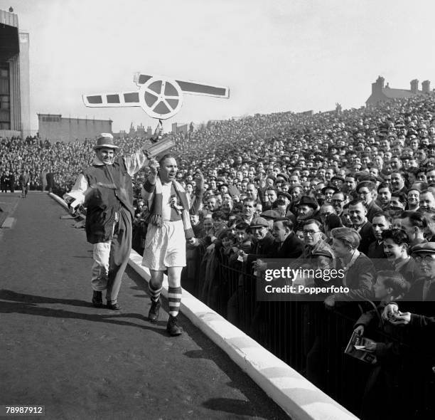 Highbury Stadium, London, Arsenal supporters on the packed terrace as two cheerleaders parade in front