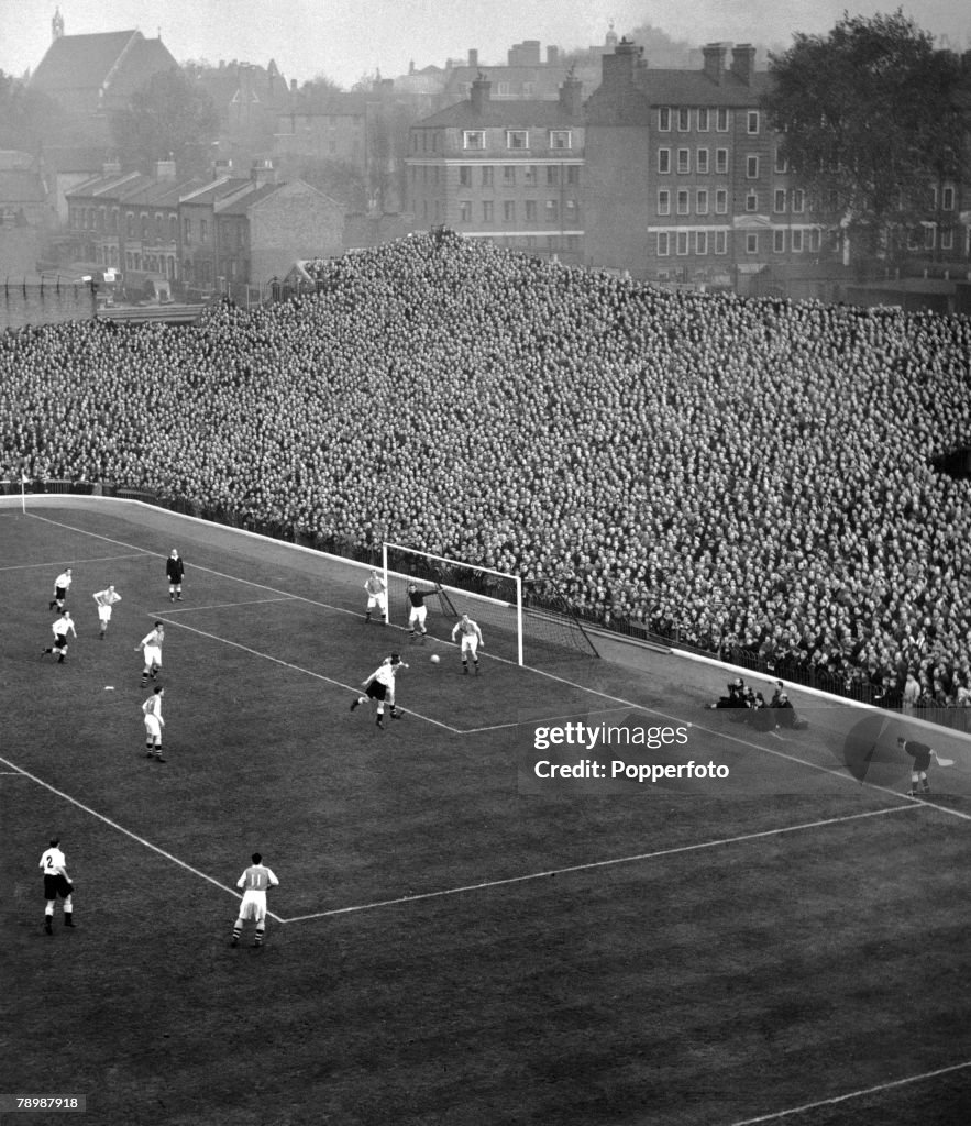 Sport. Football. pic: 1950. An aerial shot shows action from an Arsenal home match at Highbury Stadium, London, showing a packed terrace at the famous "Clock End".
