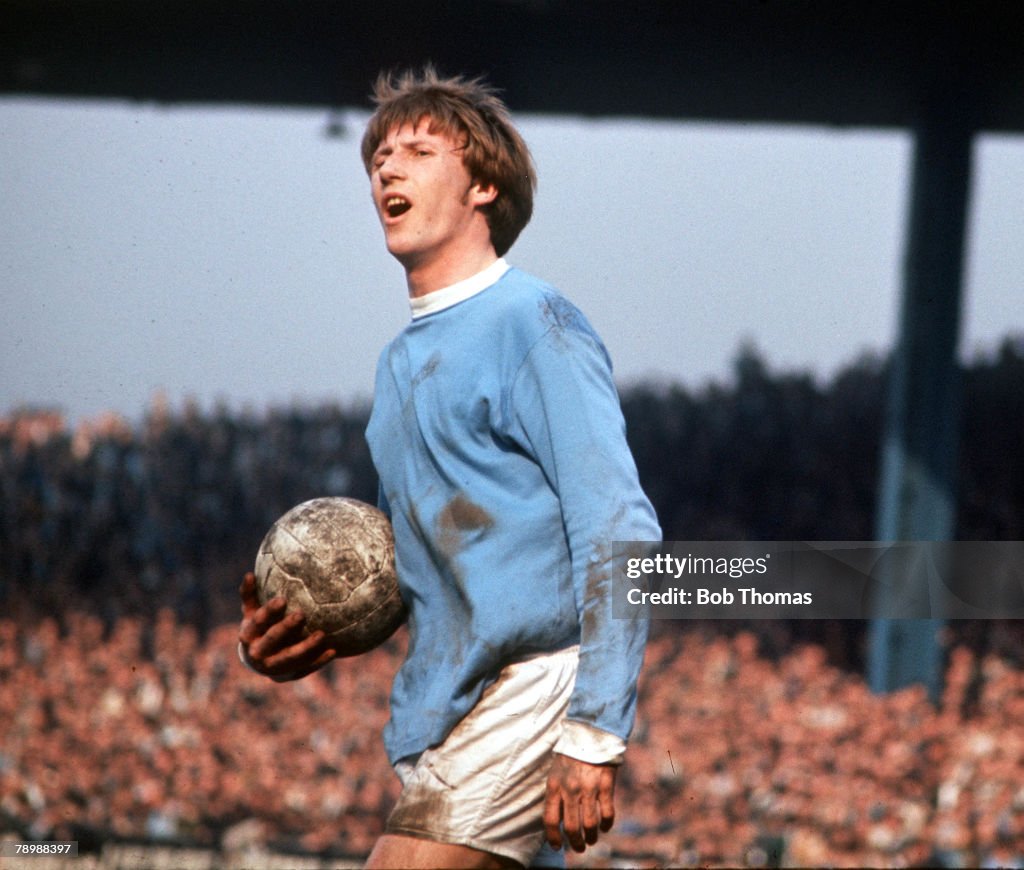 Football. 1970's. Manchester City+s Colin Bell protesting a decision as he holds the ball in his hand.