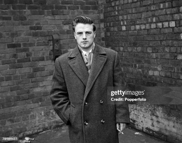 Football, Circa 1950's, Manchester United's Albert Scanlon in a long coat holding a cigarette