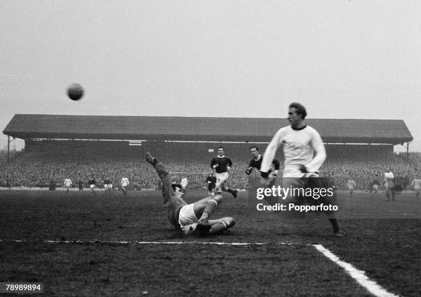 Football, Oakwell, Barnsley, February 1964, Barnslay v Manchester United, Manchester United's Denis Law chips the ball over the Barnsley goalkeeper