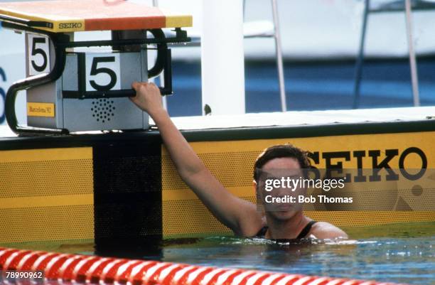 Hong Qian of China looks on from the pool after tying the world record in the Women's 100 meter Butterfly at 58.62 during the 1992 Olympic Games in...