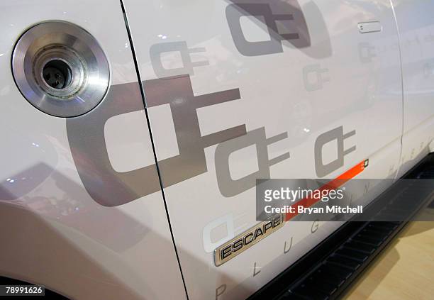 The plug-in port is seen on the Ford Escape Plug-In Hybrid on display during the press preview days at the North American International Auto show at...