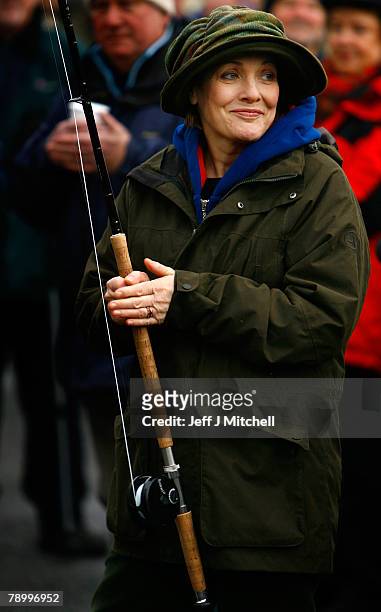 Fiona Armstrong, helps anglers mark the opening of the salmon fishing season on the River Tay at Kenmore January 15, 2008 in Kenmore, Scotland. New...