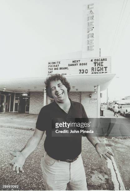 Portrait of American concert and cinema promoter Jon Stoll as he laughs in front of the Carefree Center, a music and film theatre owned by his...