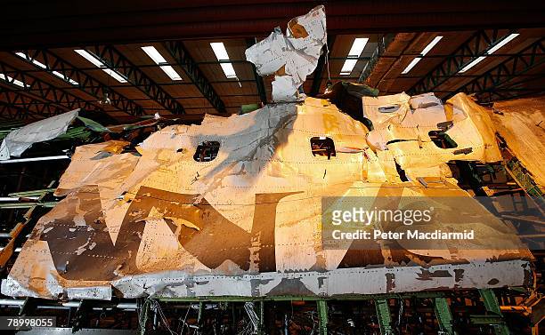 The reconstructed remains of the upper deck section of Pan Am flight 103 lie in a warehouse on January 15, 2008 in Farnborough, England. The Air...