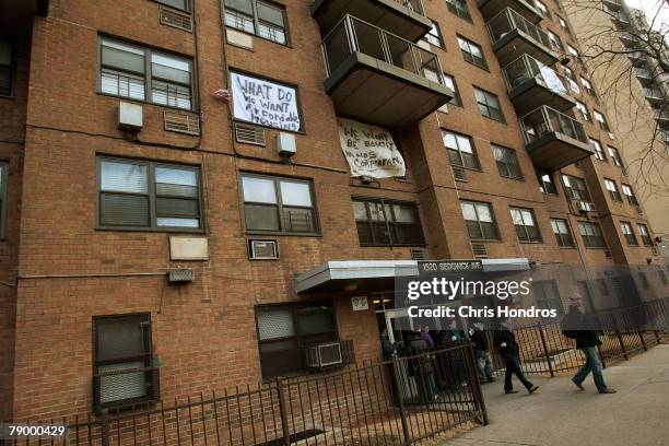 People walk out of 1520 Sedgwick Avenue, a building considered by many to be the birthplace of the popular "hip hop" style of music January 15, 2008...