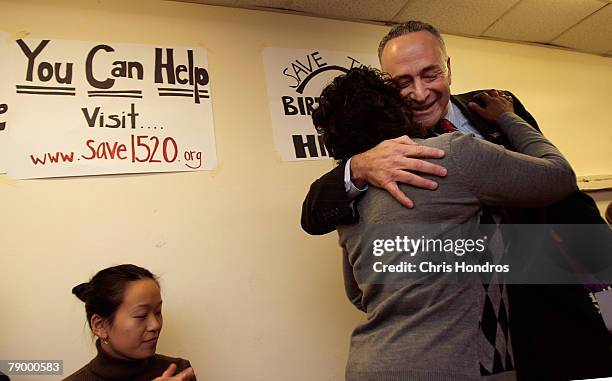 Sen. Charles Schumer hugs resident Gloria Robinson during a press conference about the fate of 1520 Sedgwick Avenue, a building considered by many to...