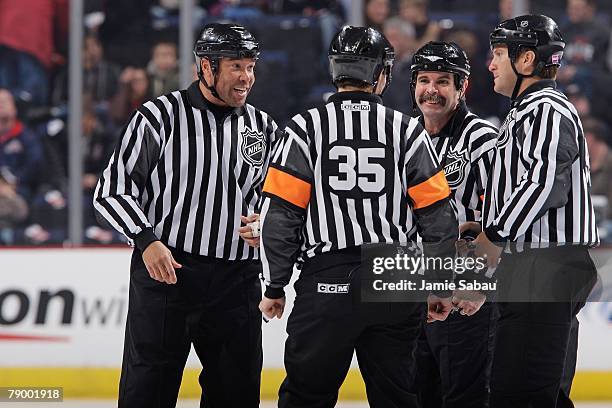 Referees Bill McCreary , Dean Warren and linesman Jay Sharrers and Jonny Murray talk at center ice before the start of a game between the Columbus...